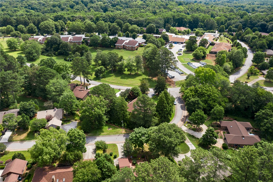 34 Hickory Way Clemson, SC 29631 - Photo 39 of 39 An aerial perspective showcases a verdant residential neighborhood with winding roads and mature trees.
