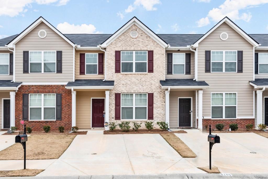 6109 Rockaway Road Atlanta, GA 30349 - Photo 1 of 1 a front view of a house with yard and parking