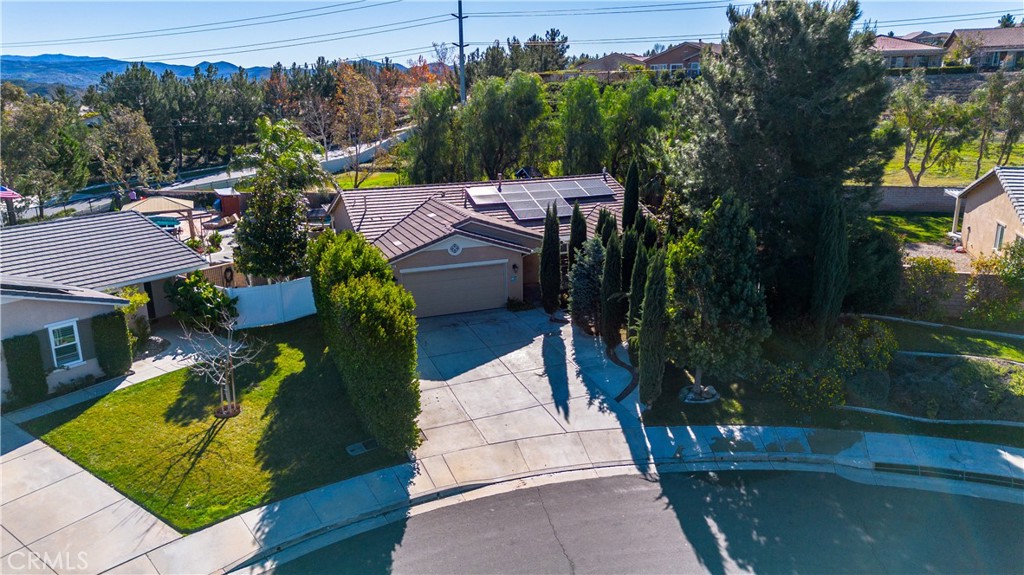 an aerial view of a house with swimming pool garden and mountain view