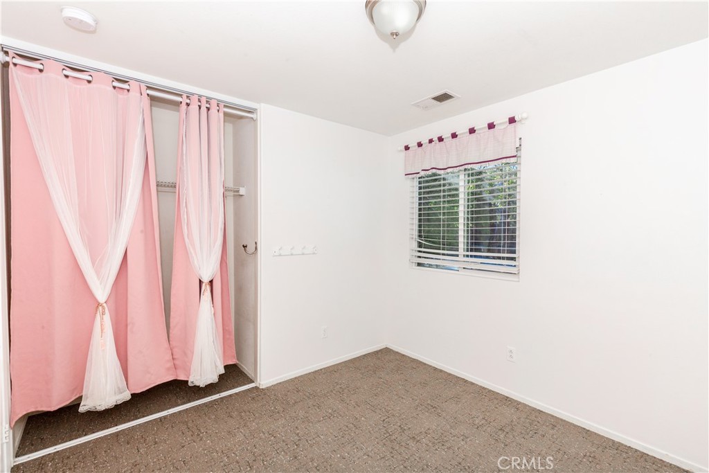 1457 Faircliff Street Beaumont, CA 92223 - Photo 16 of 37 a view of a bedroom with window and a window