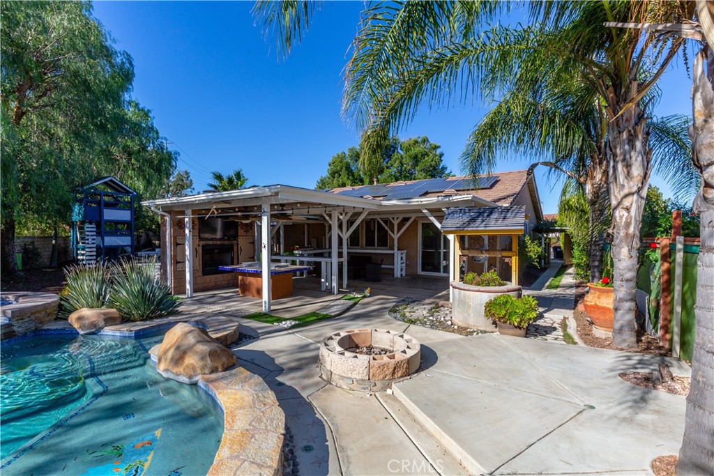 1457 Faircliff Street Beaumont, CA 92223 - Photo 25 of 37 a view of a house with backyard sitting area and swimming pool