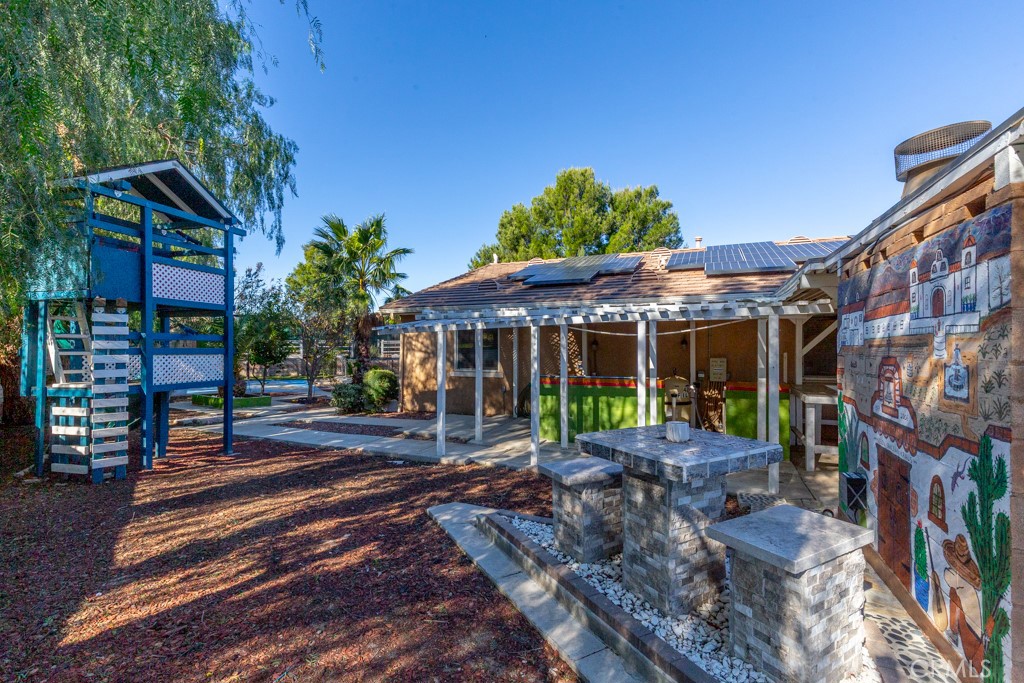 1457 Faircliff Street Beaumont, CA 92223 - Photo 31 of 37 a view of a patio with a table and chairs under an umbrella
