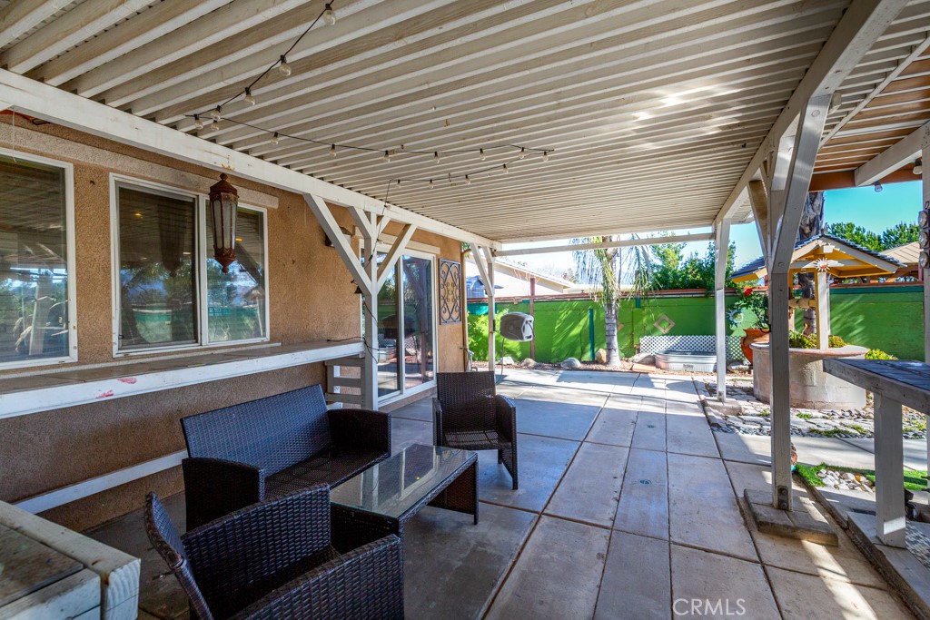 1457 Faircliff Street Beaumont, CA 92223 - Photo 35 of 37 a view of a patio with table and chairs potted plants with floor to ceiling window