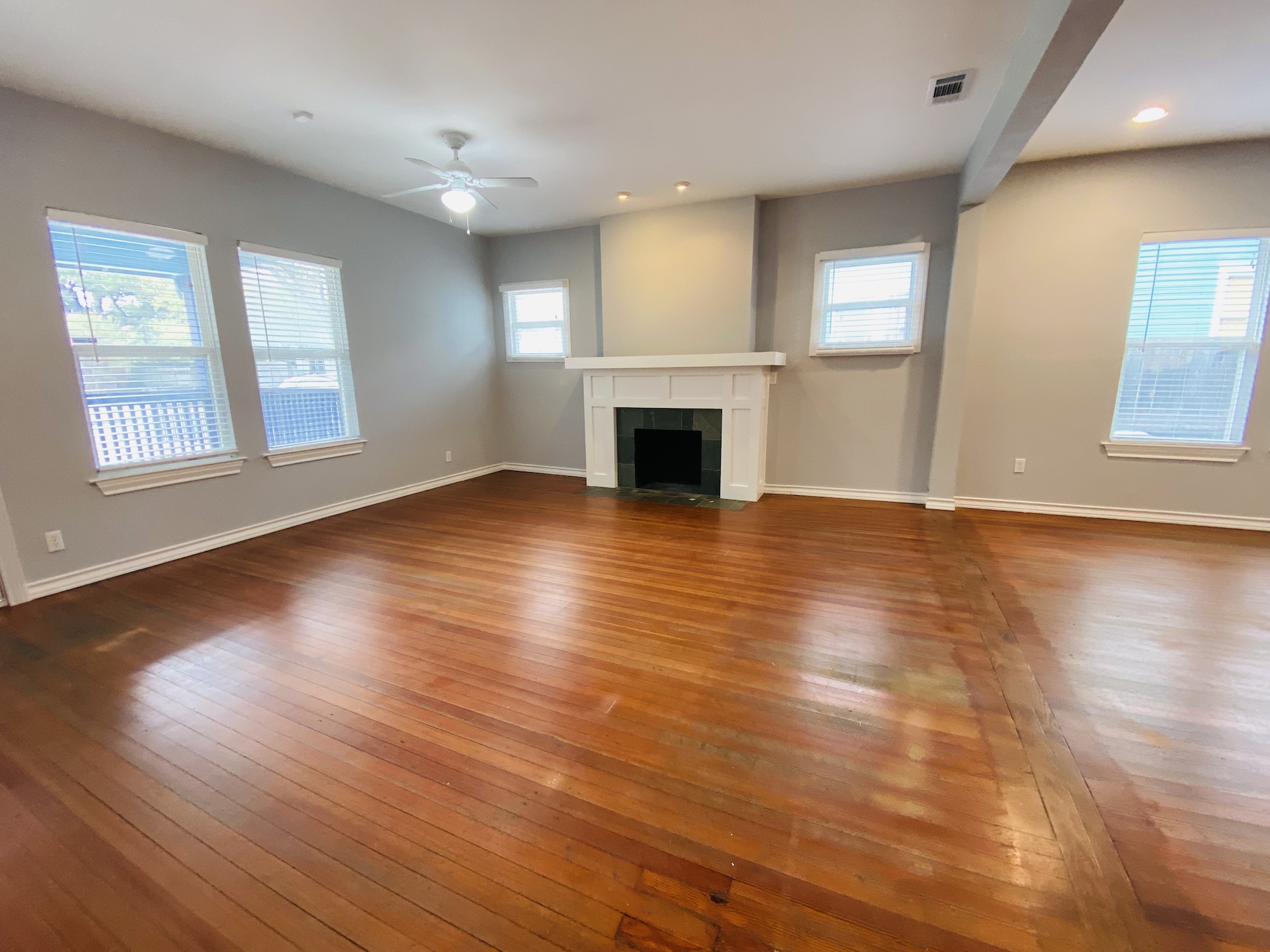 404 East 35th Street, Unit A Austin, TX 78705 - Photo 5 of 36 an empty room with wooden floor fireplace and windows