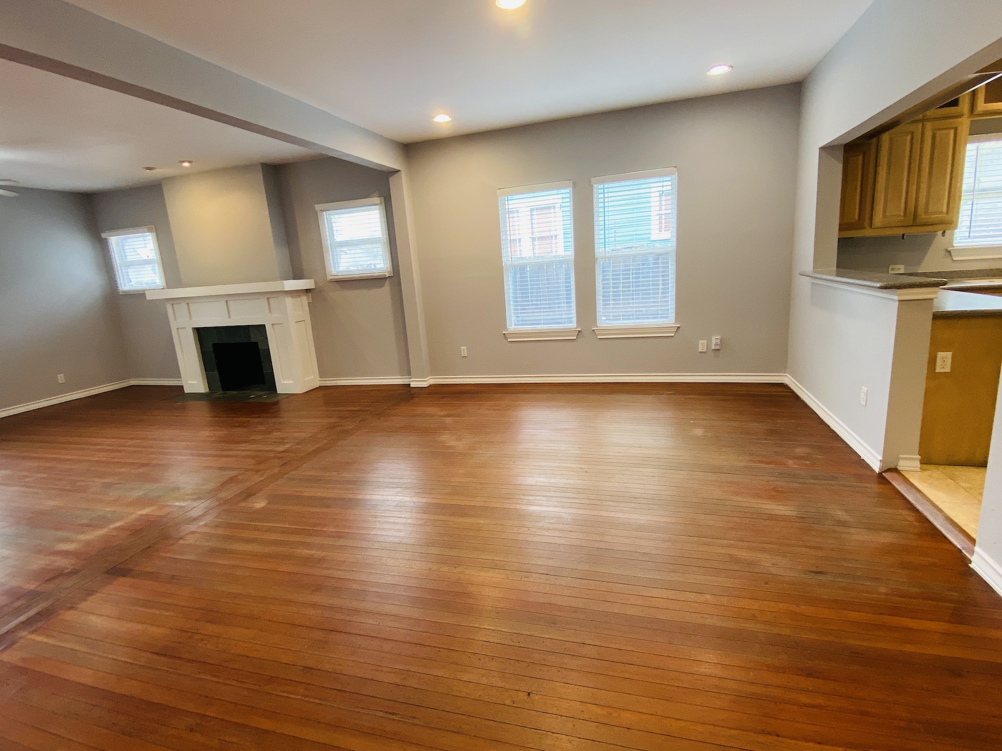 404 East 35th Street, Unit A Austin, TX 78705 - Photo 9 of 36 an empty room with wooden floor fireplace and windows