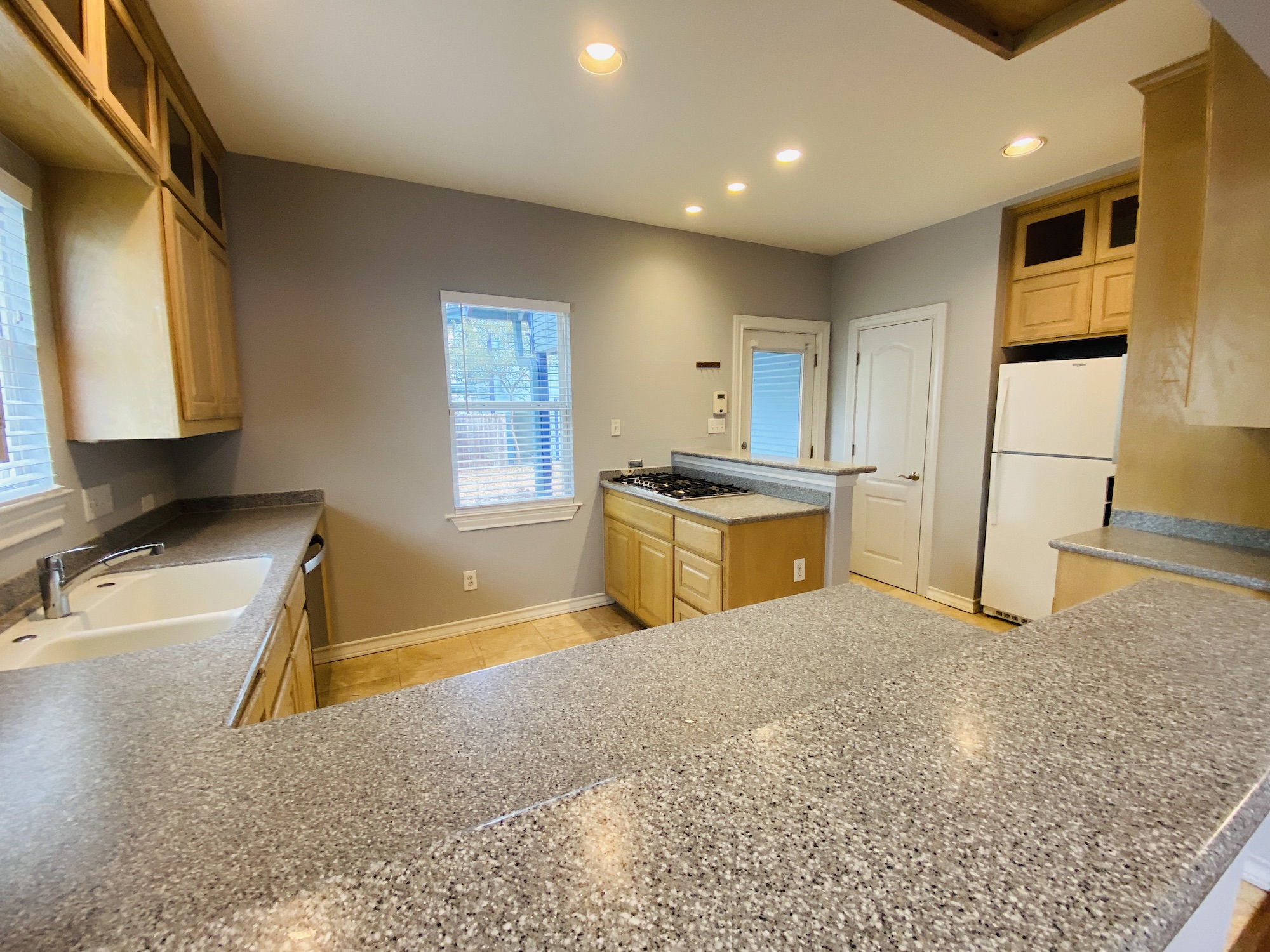 404 East 35th Street, Unit A Austin, TX 78705 - Photo 10 of 36 a kitchen with stainless steel appliances granite countertop a sink stove and refrigerator