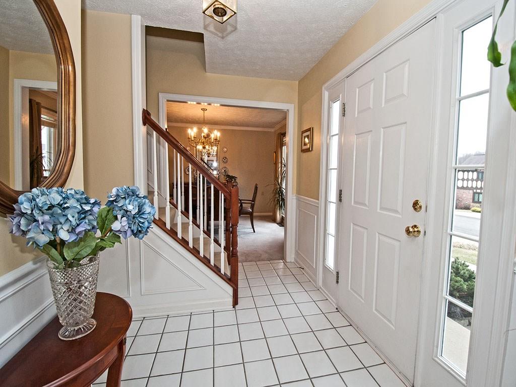 208 Ruth Way McDonald, PA 15057 - Photo 2 of 23 Spacious entry welcomes guests. Tile floor, lots of wall space for furnishings, shadowbox molding and chair rail. Front door w/sidelights provides natural light. Center Hall floor plan w/living room and dining room on either side.