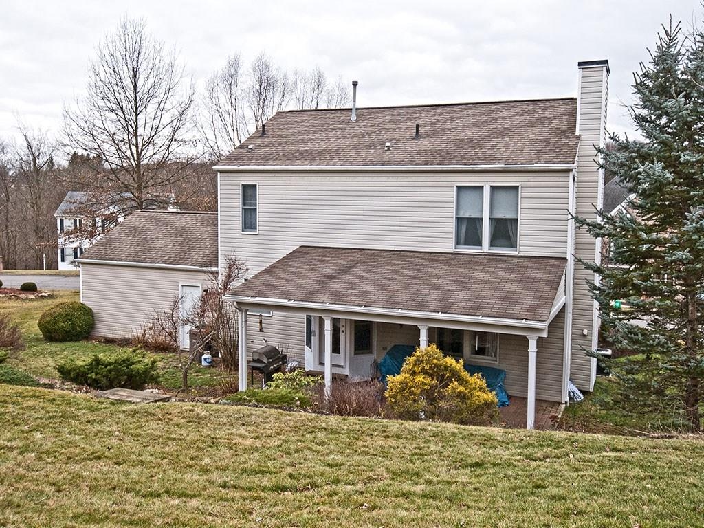208 Ruth Way McDonald, PA 15057 - Photo 17 of 23 The back of the house is as lovely as the front with the covered paver patio. Stone steps lead from the sitting area to the lawn. Landscaping is abundant on all sides with mature shrubs and decorative trees. A convenient rear door leads from the garage to the back of the property.
