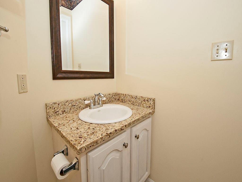 208 Ruth Way McDonald, PA 15057 - Photo 9 of 23 First floor powder room features light colored vanity and granite counter top.