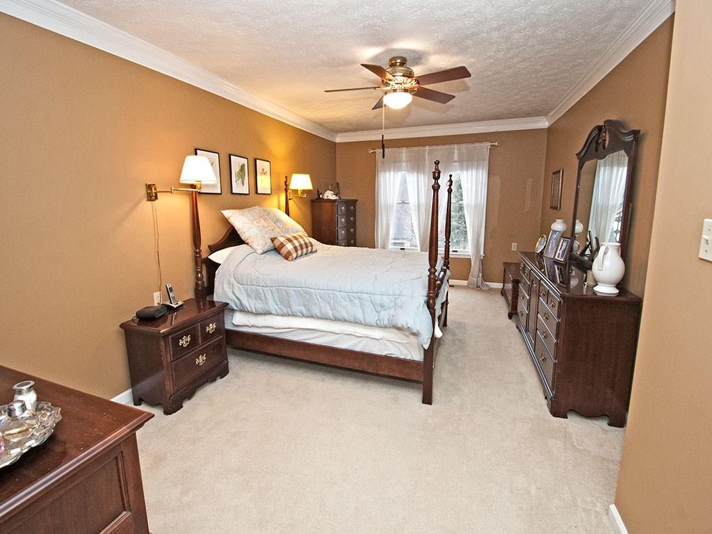 208 Ruth Way McDonald, PA 15057 - Photo 10 of 23 Elegant master bedroom has a ceiling fan and crown molding. Neutral carpet, large closet and adjoining bath with double bowl vanity. Large double window overlooks the front lawn and landscape.