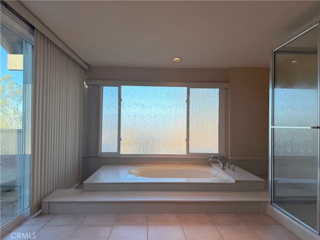 a view of entryway with a bathtub and large window