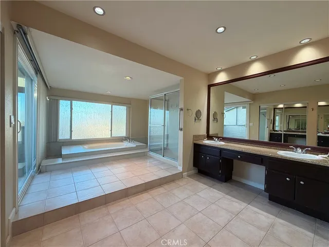 a large bathroom with a large tub and sink
