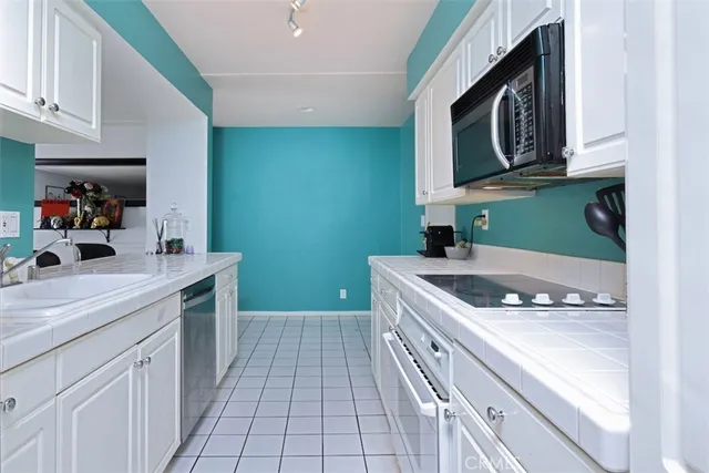 a kitchen with a sink cabinets and wooden floor