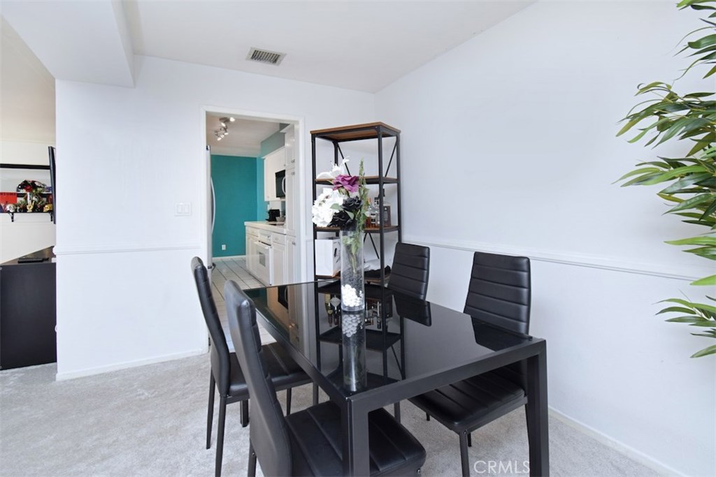 5050 Coldwater Canyon Avenue, Unit 306 Sherman Oaks, CA 91423 - Photo 17 of 24 a view of a dining room with furniture and wooden floor