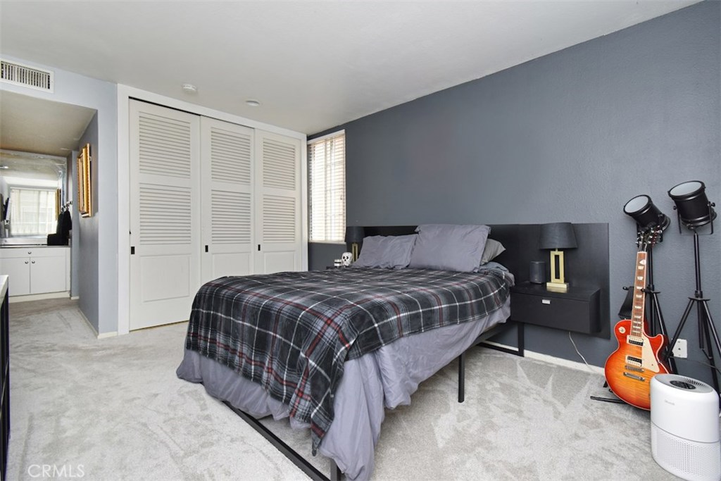 5050 Coldwater Canyon Avenue, Unit 306 Sherman Oaks, CA 91423 - Photo 21 of 24 a bedroom with a bed and a window