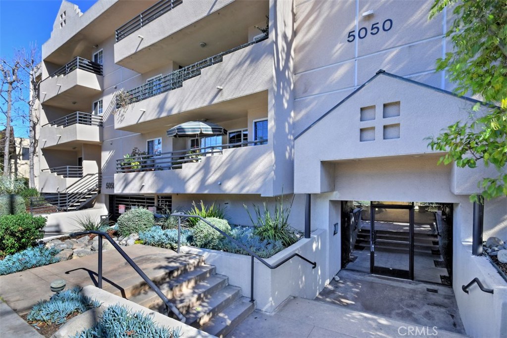 5050 Coldwater Canyon Avenue, Unit 306 Sherman Oaks, CA 91423 - Photo 3 of 24 a front view of a house with a yard
