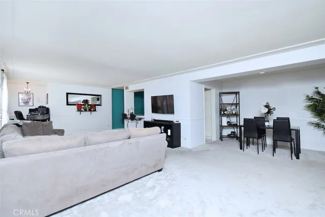 a view of a workspace with furniture and chandelier