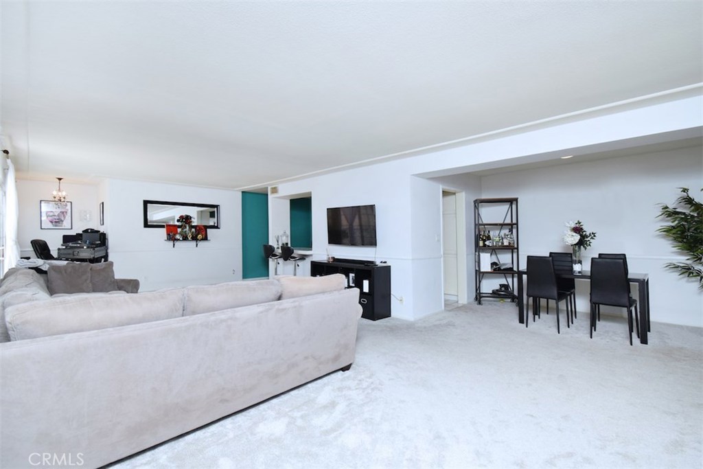 5050 Coldwater Canyon Avenue, Unit 306 Sherman Oaks, CA 91423 - Photo 7 of 24 a living room with furniture and a flat screen tv