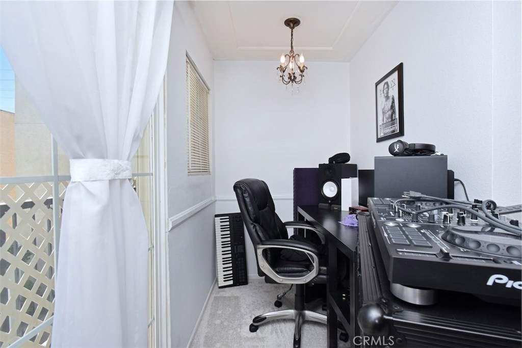 5050 Coldwater Canyon Avenue, Unit 306 Sherman Oaks, CA 91423 - Photo 8 of 24 a view of a workspace with furniture and chandelier