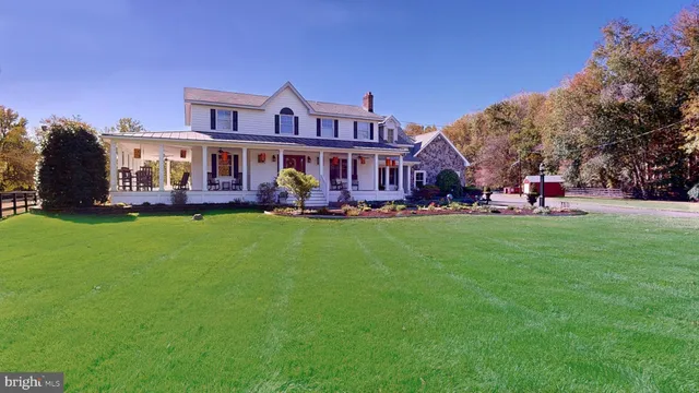 a front view of a house with a yard table and trees
