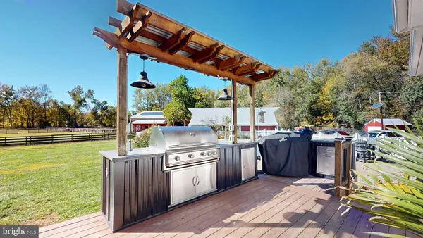 a kitchen with stainless steel appliances granite countertop a refrigerator and a wooden cabinets