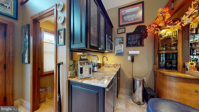 a large kitchen with stainless steel appliances granite countertop a stove and a wooden cabinets