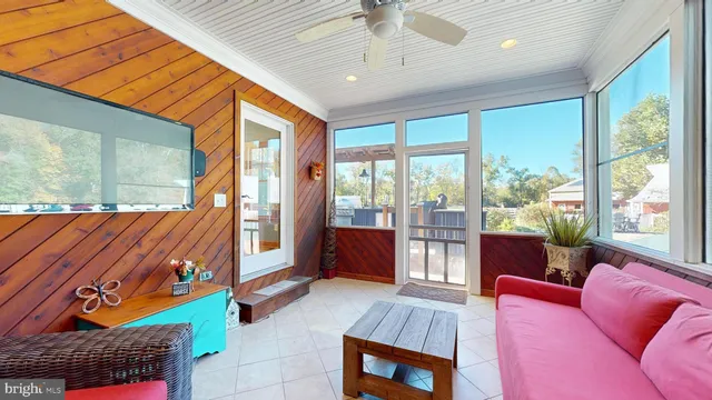 a view of a dining room with furniture and a chandelier
