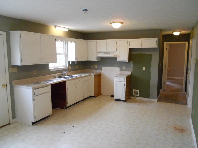 958 Rocky Valley Road Lebanon, TN 37090 - Photo 3 of 20 a kitchen with stainless steel appliances granite countertop a refrigerator a sink a stove and white cabinets