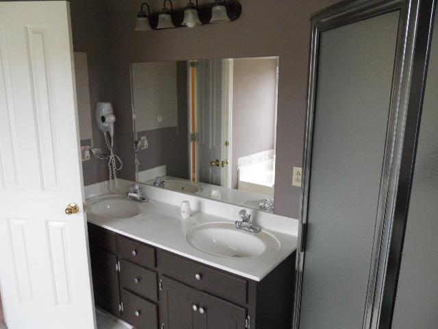 958 Rocky Valley Road Lebanon, TN 37090 - Photo 6 of 20 a bathroom with a double vanity sink and a mirror