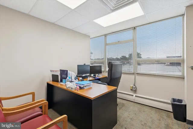 a large white kitchen with a large window