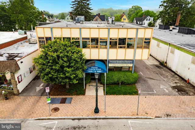 view of a brick house with a yard