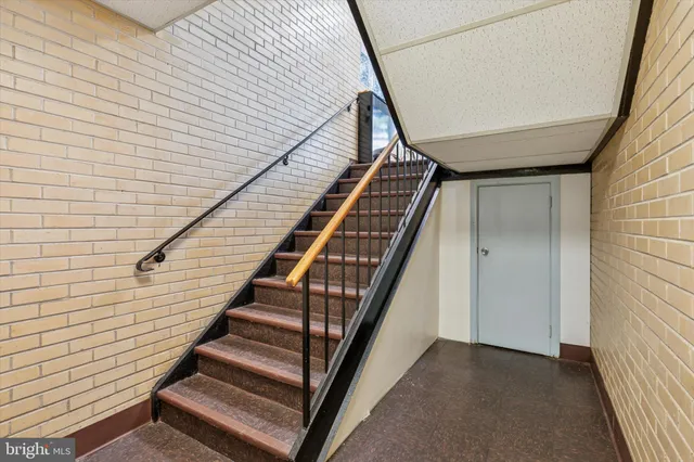 a living room with furniture and a book shelf