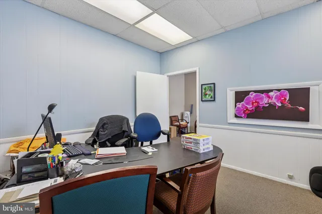 a view of a workspace with furniture and a window