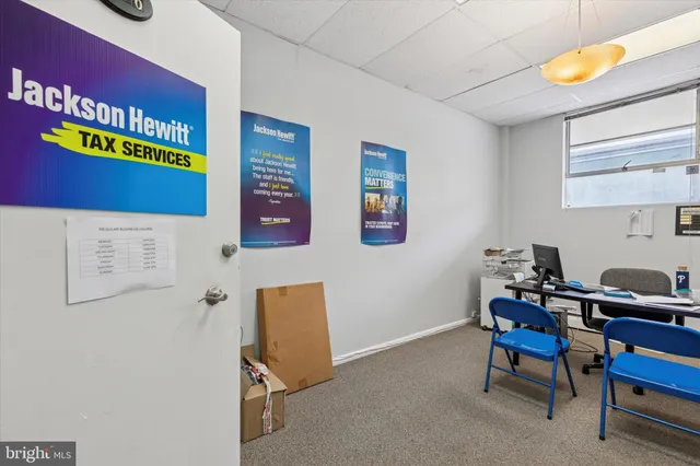 a view of entryway with workspace and wooden floor