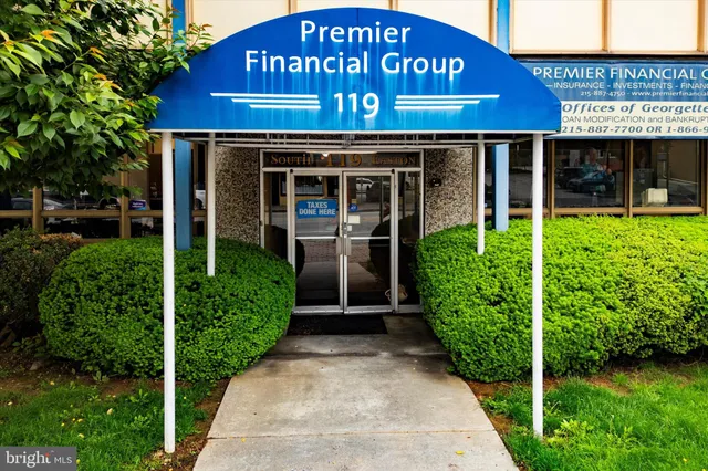 a view of a house with large windows and a yard