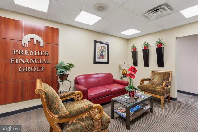 a view of a dining room with furniture and a chandelier