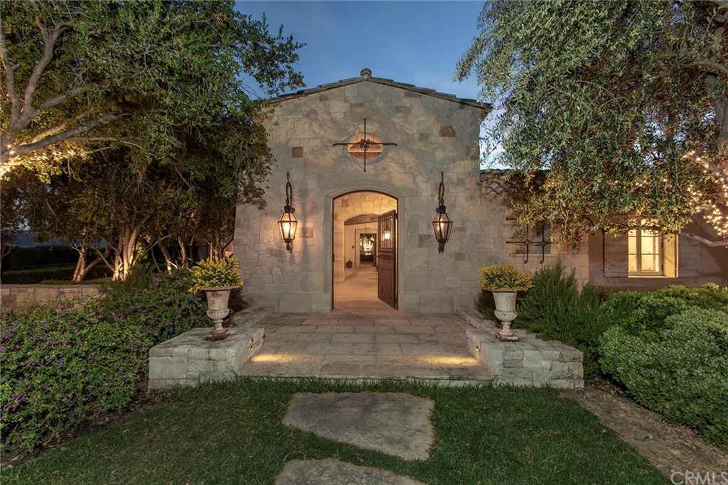 11 Needle Grass Irvine, CA 92603 - Photo 3 of 23 a large stone house with a yard