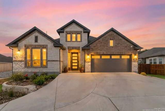 a front view of a house with a yard and garage