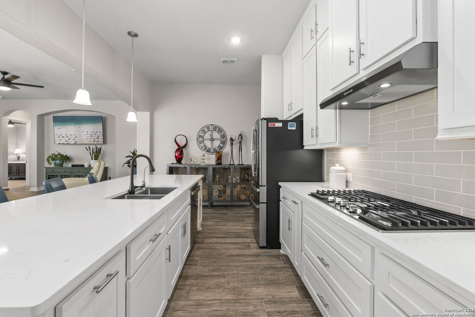 705 Tree Top Pass New Braunfels, TX 78130 - Photo 8 of 49 a kitchen with kitchen island granite countertop a sink a stove and cabinets