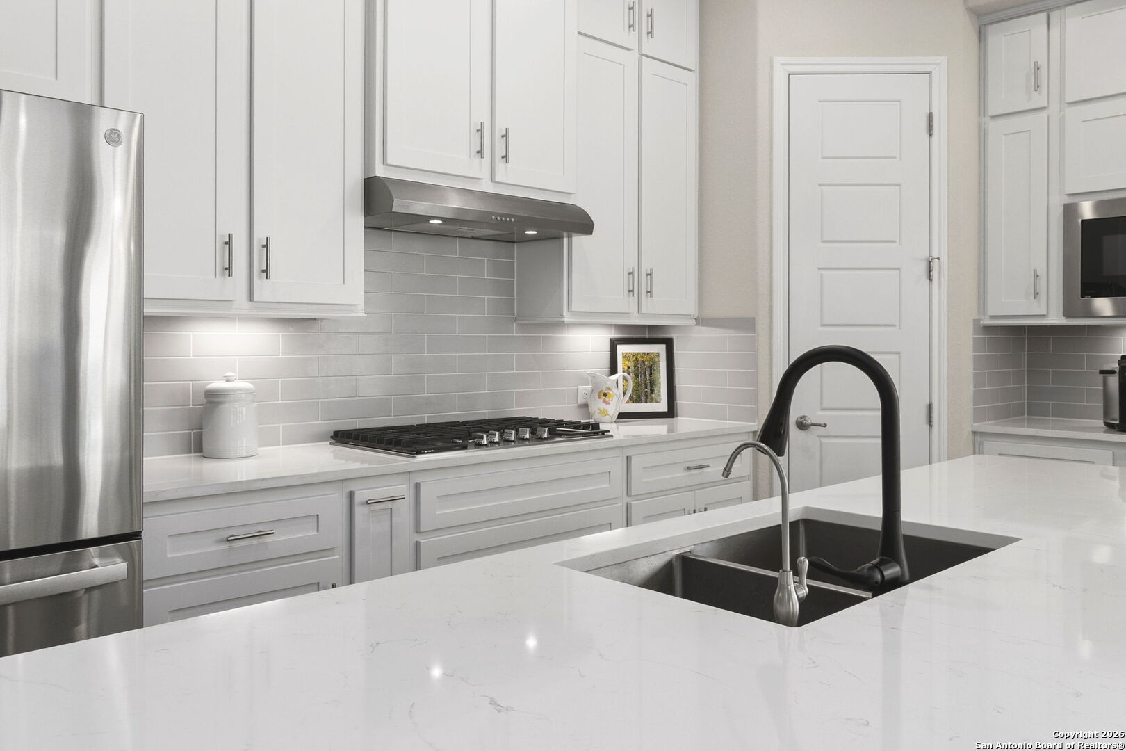 705 Tree Top Pass New Braunfels, TX 78130 - Photo 9 of 49 a kitchen with granite countertop a sink stainless steel appliances and cabinets
