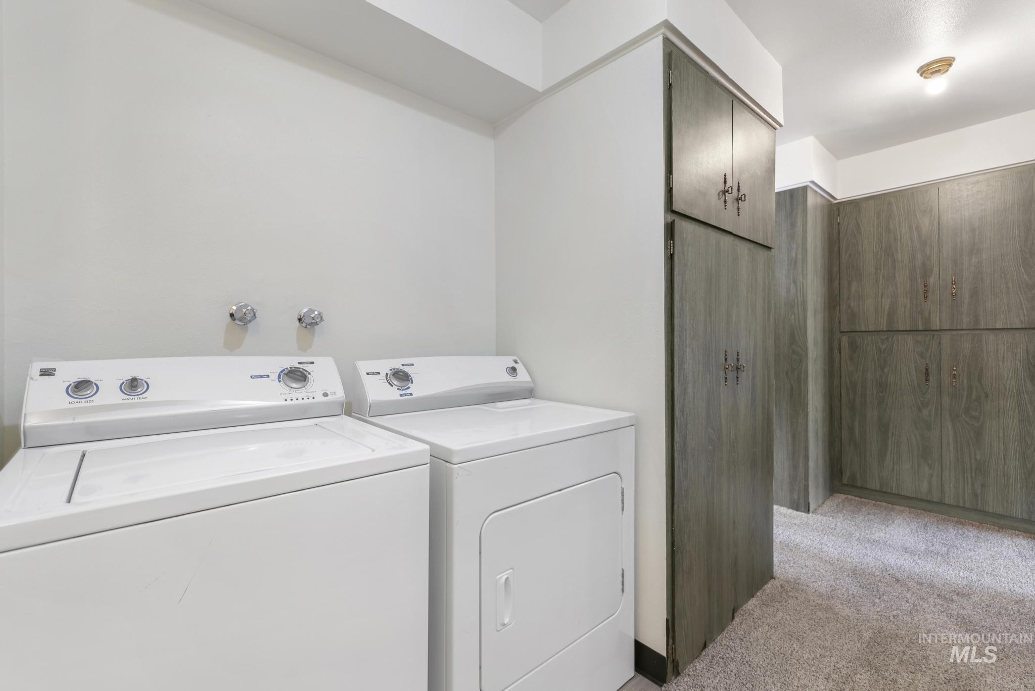 409 Clear Lakes Road Buhl, ID 83316 - Photo 24 of 43 Laundry room featuring light colored carpet and separate washer and dryer