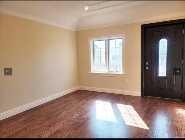 an empty room with windows and entrance