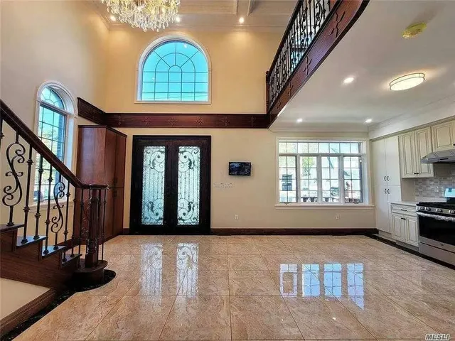 a view of an entryway with wooden floor and door