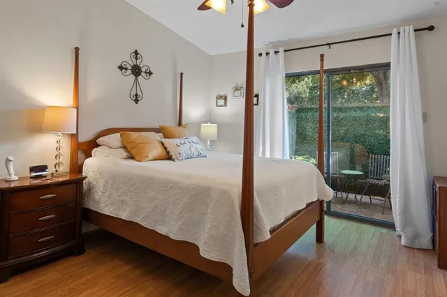 a bedroom with a bed and a painting on the wall