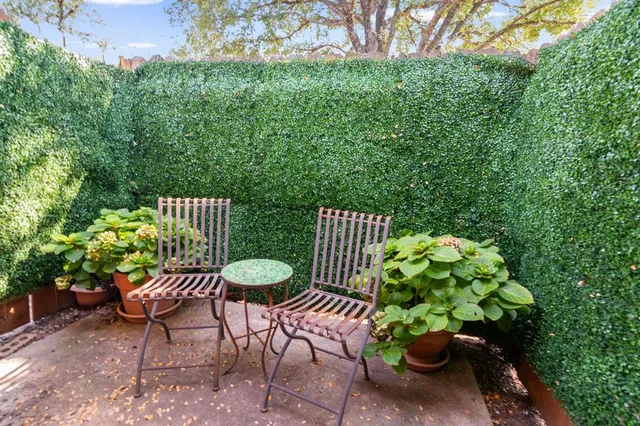 a view of a chair and table in the backyard