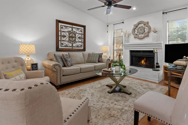a living room with furniture a clock and a fireplace