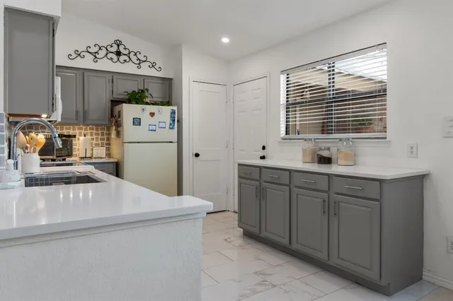 a kitchen with sink cabinets and window