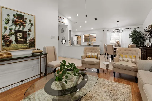 a living room with furniture and a dining table
