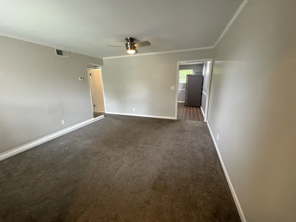 an empty room with a empty space and windows