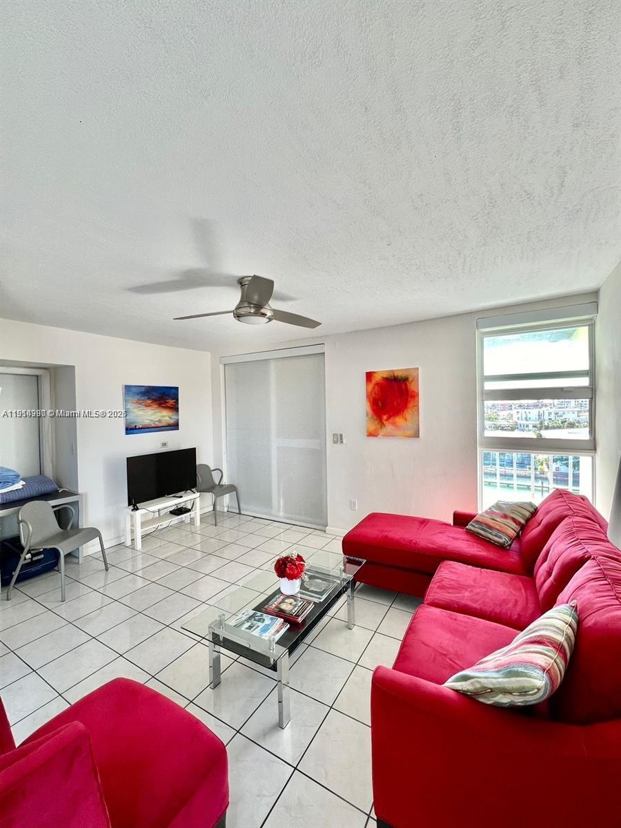 8001 Crespi Boulevard, Unit 6D Miami Beach, FL 33141 - Photo 11 of 29 a bedroom with furniture and a flat screen tv
